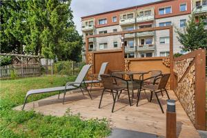 a patio with chairs and a table on a wooden deck at Fewo Gustav Melkert Str. 5A in Röbel