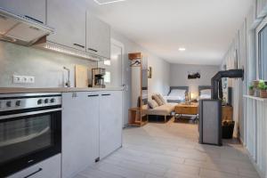 a kitchen with white cabinets and a living room at Fewo Gustav Melkert Str. 5A in Röbel