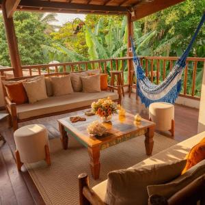 a living room with a hammock on a porch at Residência Thomas in Itacaré
