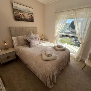 a bedroom with a bed with two towels on it at Gordon House in Wimborne Minster