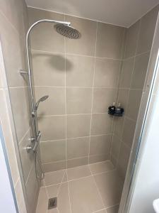 a shower with a glass door in a bathroom at Blue sunset - Appartement avec vue mer in Papeete +14 photos