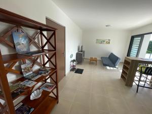 a living room with a book shelf and a desk at Blue sunset - Appartement avec vue mer in Papeete
