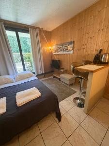 a hotel room with a bed and a desk with a computer at Eden Studios Chamonix Centre in Chamonix
