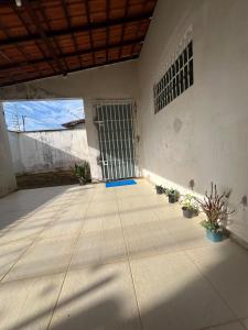 a room with potted plants in front of a door at Hostel Coimbra Araçagi in Macajatuba