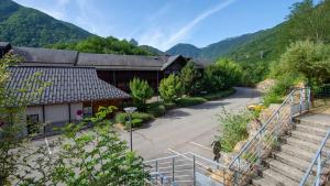 a building with a staircase next to a mountain at Les Chalets d Ax N120 2P6 in Ax-les-Thermes