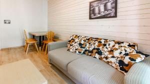 a living room with a couch and a table at Les Chalets d Ax N120 2P6 in Ax-les-Thermes