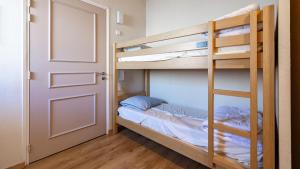 a room with two bunk beds and a door at Les Chalets d Ax N120 2P6 in Ax-les-Thermes +9 photos
