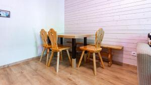 a wooden table and four chairs in a room at Les Chalets d Ax N120 2P6 in Ax-les-Thermes