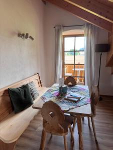 a bedroom with a bed and a table and chairs at Ferienwohnung Grecht in Uffing +18 photos