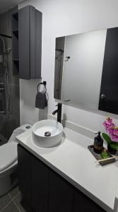 a white bathroom with a sink and a toilet at apartamento tipo loft en sabaneta in Sabaneta +12 photos