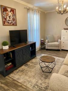 a living room with a television and a couch at Lucky 13 Condo in Starkville