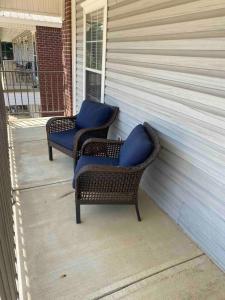 two wicker chairs with blue cushions sitting on a porch at Lucky 13 Condo in Starkville