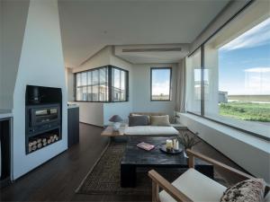 a living room with a couch and a fireplace at Things grow in their native land in Ulanqab