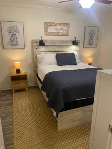 a bedroom with a large bed with a blue blanket at Lucky 13 Condo in Starkville
