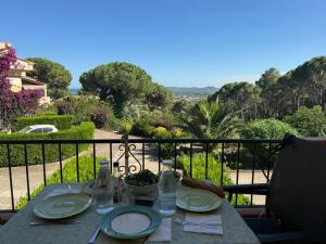 a table with plates of food on a balcony at La dorada 8 in Torroella de Montgrí
