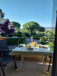 a table with food on it on a balcony at La dorada 8 in Torroella de Montgrí
