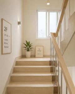 a staircase with a potted plant and a window at 온한달 in Seongnam