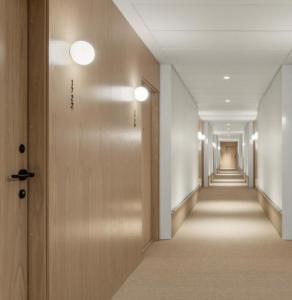 a hallway of a building with a row of doors at 온한달 in Seongnam