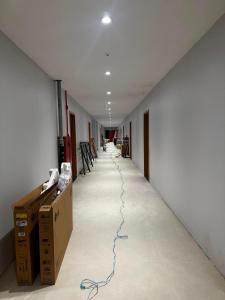 a long hallway with boxes and a cord on the floor at Arruda UMARI in Benevides +2 photos