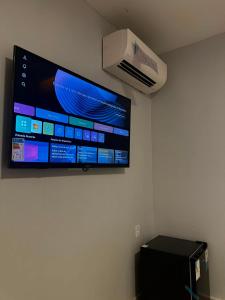 a flat screen tv hanging on a wall at Arruda UMARI in Benevides