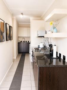 a kitchen with a black counter top in a room at MANDITAZ STUDIO in Fourways