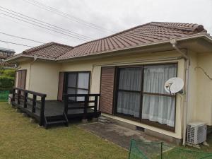 a small house with a porch and a window at Villa9 in Onjuku