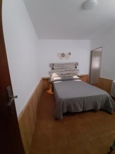 a bedroom with a bed in a white room at Mallona in Pedro Rodríguez