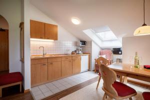 a kitchen with a table and a dining room at Wellness Ferienwohnung mit Hallenbad und Sauna in Oberaudorf