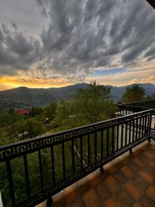 a balcony with a view of the mountains at The Elysian Villa in Murree