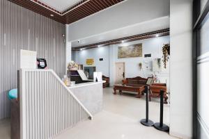 a pharmacy lobby with a couch in the background at RedDoorz Lotte near PTC MALL in Palembang