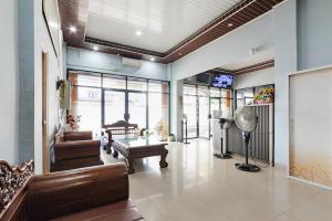 a living room with a couch and a table at RedDoorz Lotte near PTC MALL in Palembang