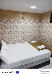 a bedroom with a large white bed in a room at New Wave Damansara Damai in Petaling Jaya