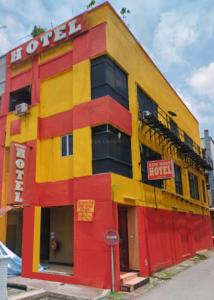 a yellow and red building with a hotel at New Wave Damansara Damai in Petaling Jaya