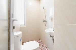 a bathroom with a toilet and a sink at RedDoorz Lotte near PTC MALL in Palembang +15 photos