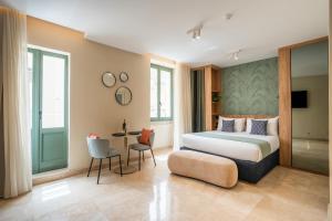 a hotel room with a bed and a table at The Three Doors in St. Julianʼs
