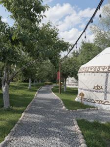 a cobblestone path in a park with a tent at 40 Rays Yurts in Bosteri
