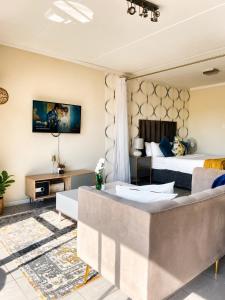 a hotel room with a bed and a couch at MANDITAZ STUDIO in Fourways