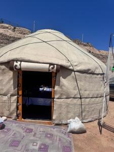 a large tent with a door in the desert at Almani yurt camp in Tong