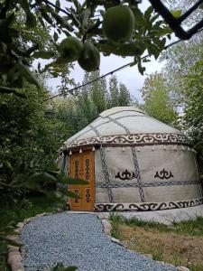 a gazebo with a door in a garden at 40 Rays Yurts in Bosteri