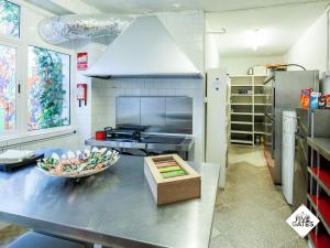 a kitchen with a table with a bowl of food on it at Hostal Five Gates in Osuna