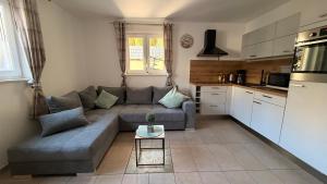 a living room with a couch and a table at Am Dollespark in Bodenheim