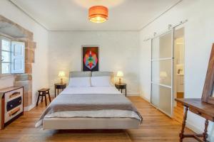 a bedroom with a large bed and two tables at Villa Vista Ajo in Ajo