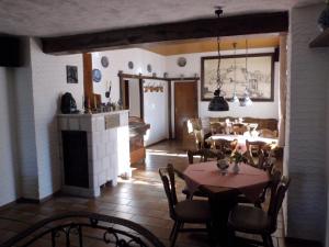 a dining room with tables and chairs and a fireplace at Hotel Restaurant Zur Pfanne in Koblenz