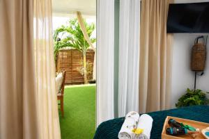 a bedroom with a bed and a sliding glass door at Le SeaZen Lodge in Sainte-Anne