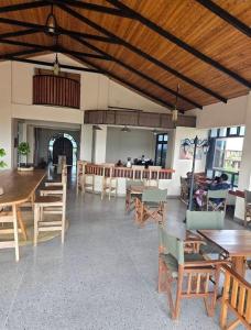 a large room with wooden tables and chairs at Pakihotels&apartment in Moshi