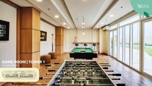 a billiard room with a pool table in the middle at Siena Tower - Gian's Nook in Manila