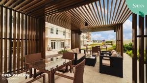 a patio with a table and chairs on a patio at Siena Tower - Gian's Nook in Manila