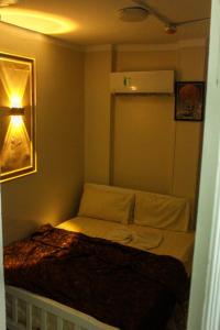 a small bedroom with a bed in a room at El Temsah Hotel in Cairo