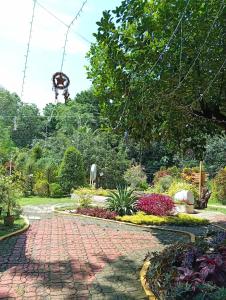 a garden with a brick walkway in a park at Ella Garden Resort in Mag-ag