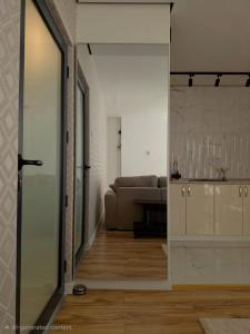 a living room with a couch and a sliding glass door at Negotin Centar Boutique Residence in Negotin